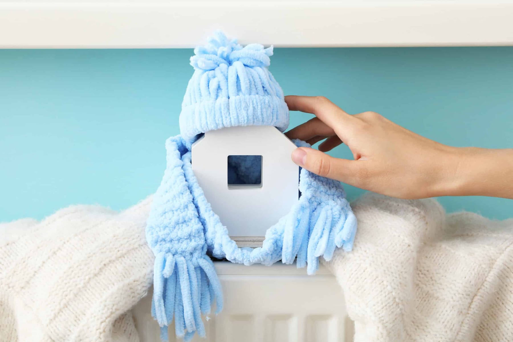 Thermostat being adjusted at the start of the heating season in a Surprise, AZ home